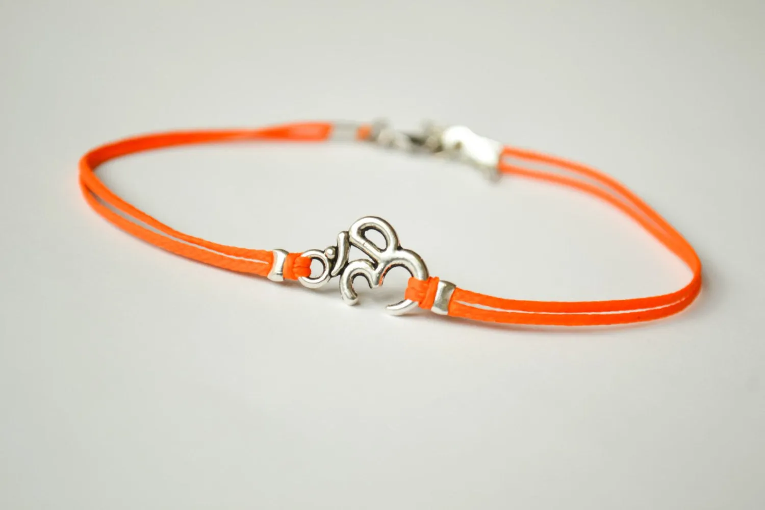 Orange cord anklet with silver Om charm, yoga jewelry